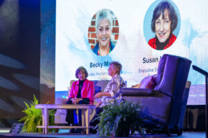 Susan Watson and Becky Mock of the Women's Resource Center on stage